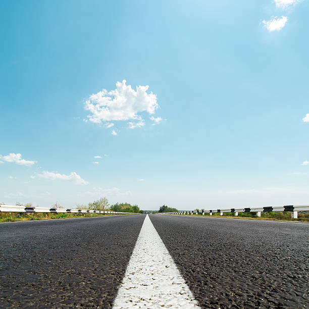 istock white line on asphalt road and sunny sky 513449089