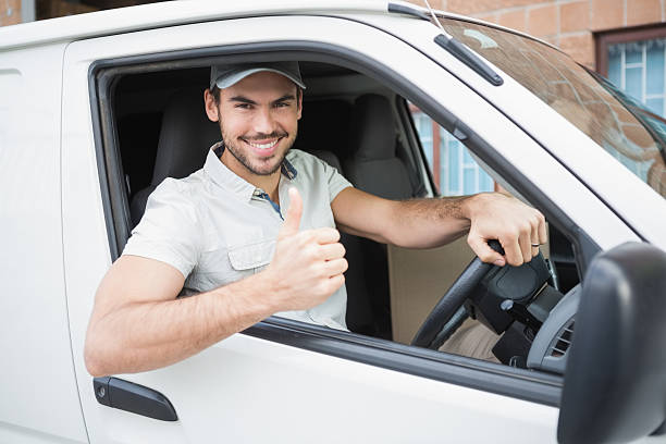 istock Delivery driver showing thumbs up driving his van 513449901