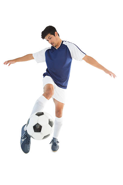 istock Fit player kicking football 513450147