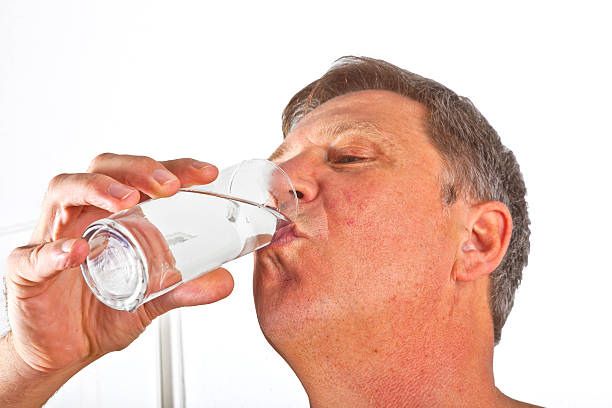 istock portrait of attractive man drinking water 513450199