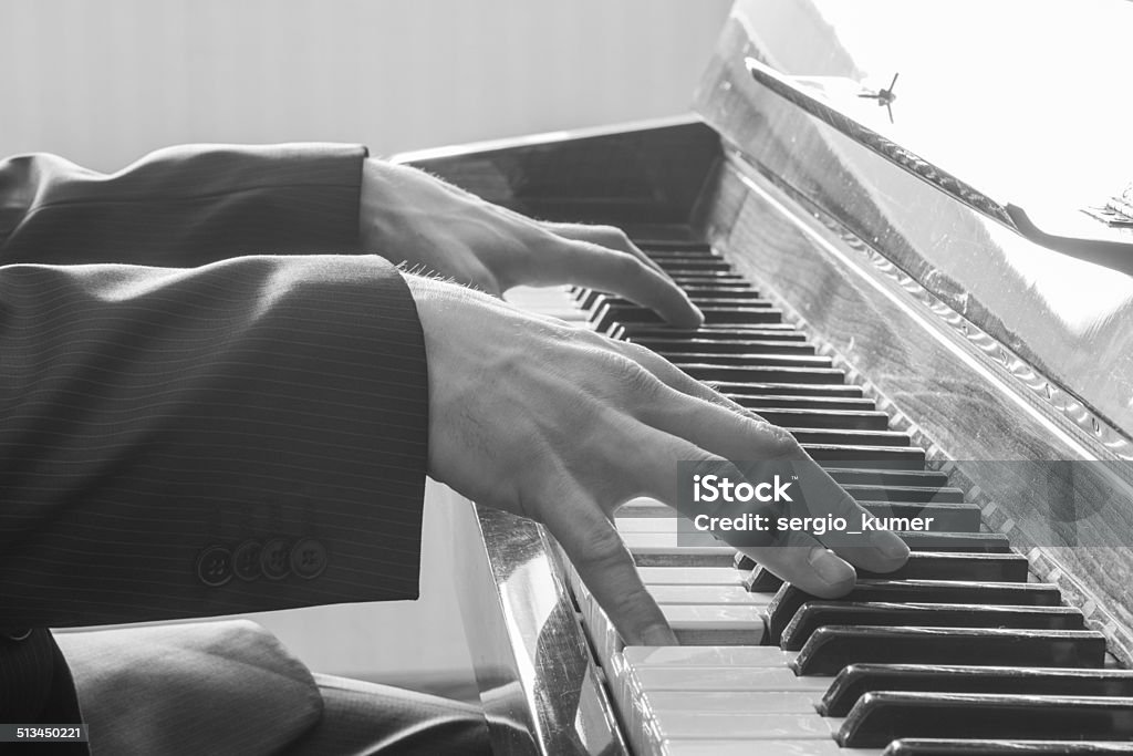 Man's hands playing the Piano. Man's hands playing the Piano. Black and White Adult Stock Photo