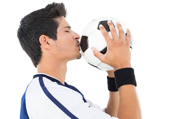 istock Handsome football player kissing ball 513468491