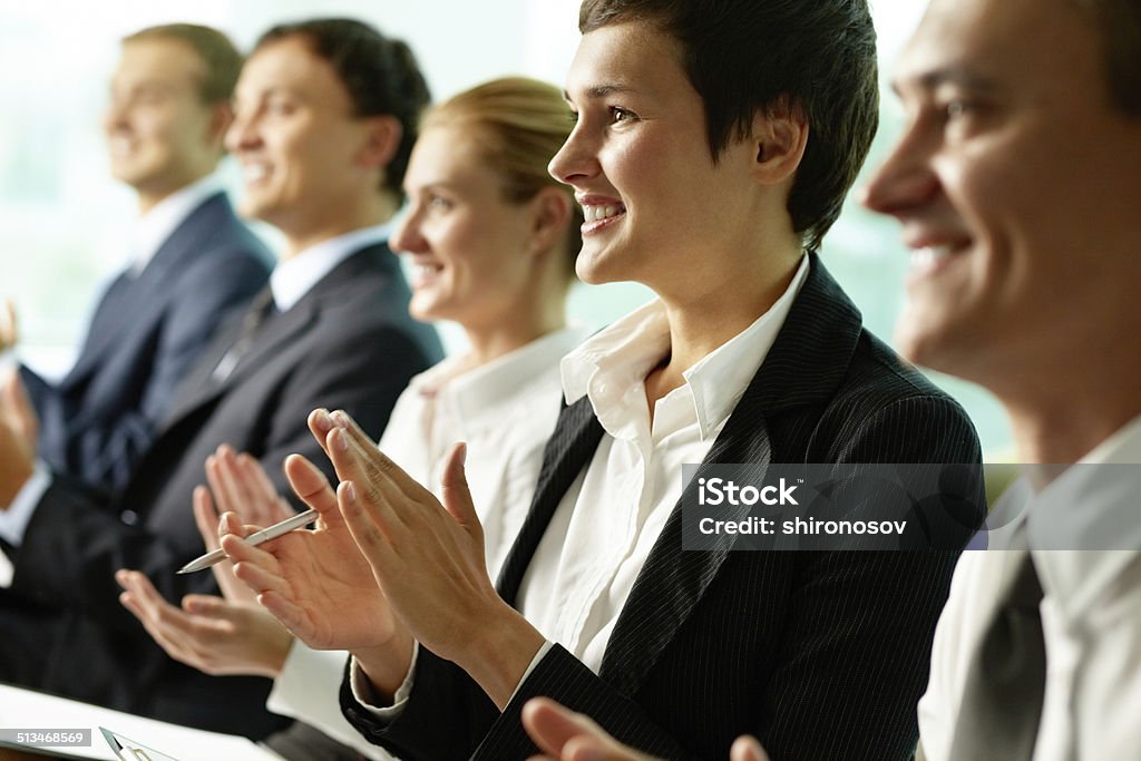 At lecture Business people sitting in a row and applauding Achievement Stock Photo