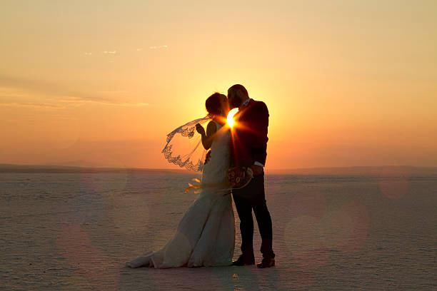 istock Bride and groom kissing on snow 513468779