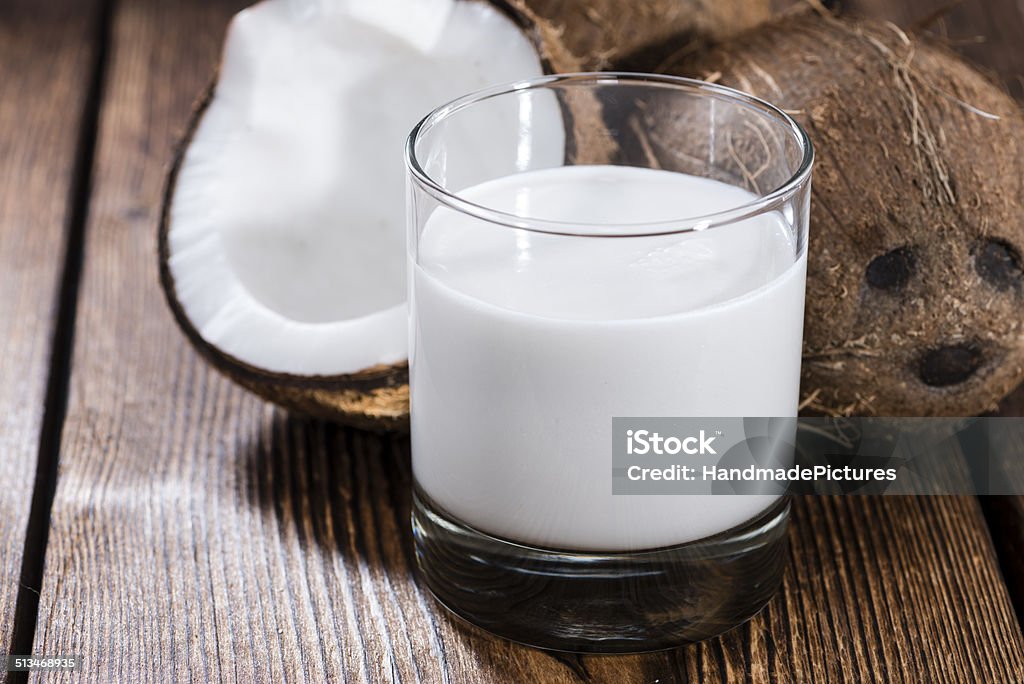Coconut Milk Coconut Milk in a glass on dark wooden background (close-up shot) Coconut Milk Stock Photo