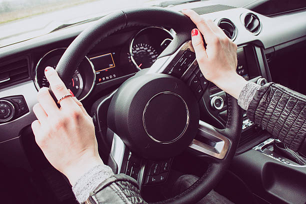 istock Close up image of female driver hands on steering wheel. 513470522