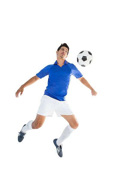 istock Fit player kicking football 513471879