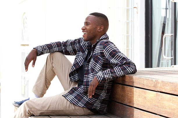 istock Happy young man sitting on a wooden bench 513471966