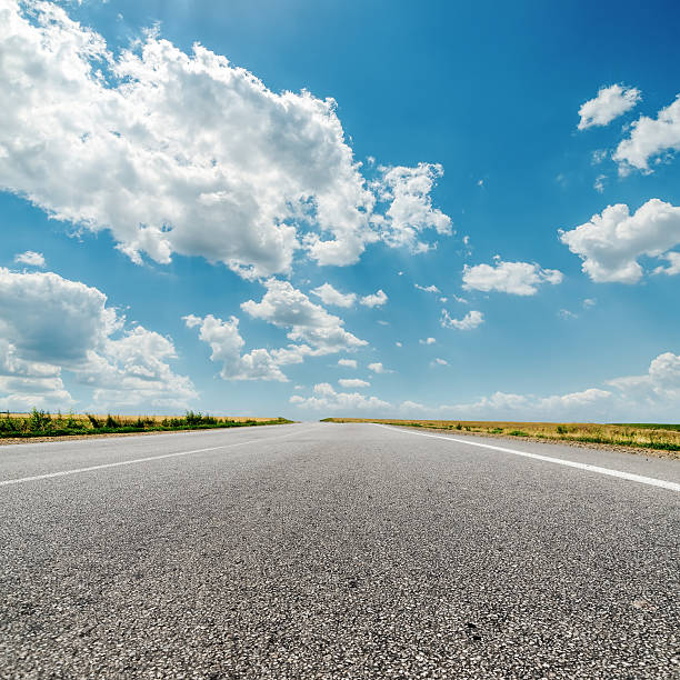 istock asphalt road to horizon and clouds over it 513472133