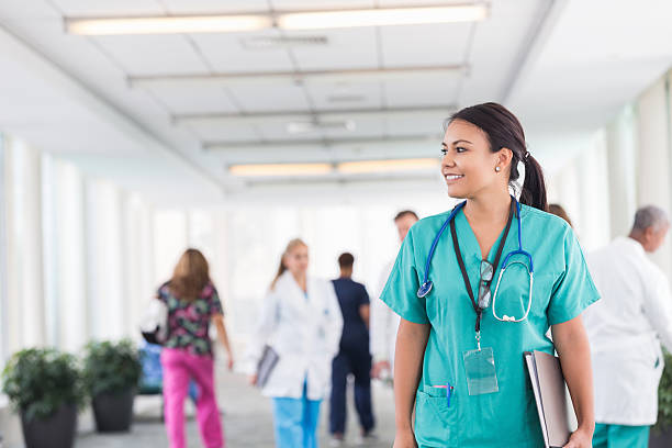 istock Confident female nurse smiling while working in busy hospital 513473593