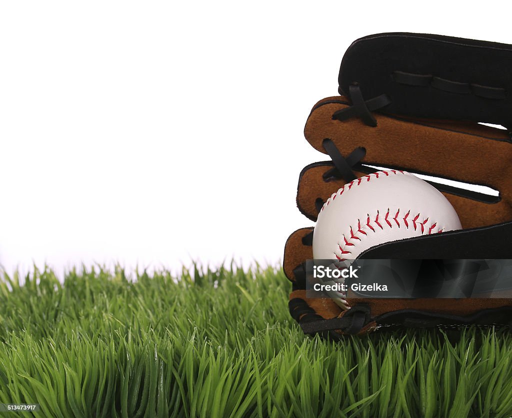 Baseball in Glove on Green Grass, isolated Baseball in Glove on Green Grass, isolated on white. Baseball - Ball Stock Photo
