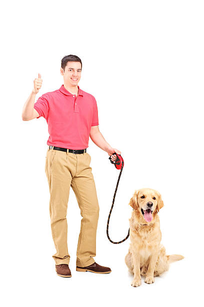 istock Young man with a dog giving thumb up 513474351
