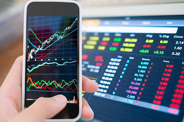 istock Using smart phone in Stock market graph 513474724
