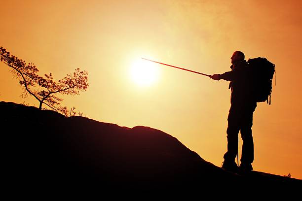 istock Tourist guide show the right way. Hiker with sporty backpack 513475180