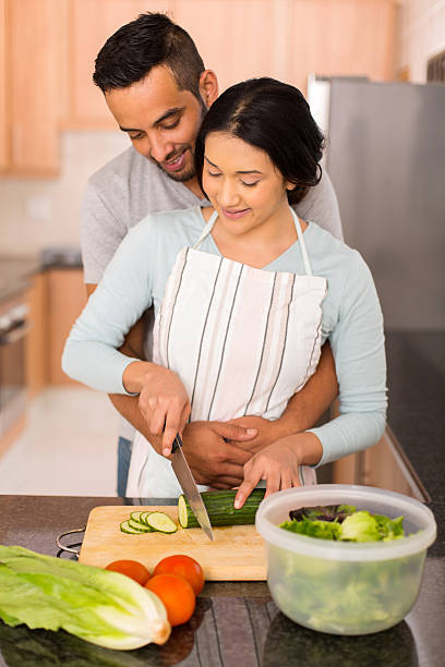 istock young indian couple chopping vegetables together 513475398