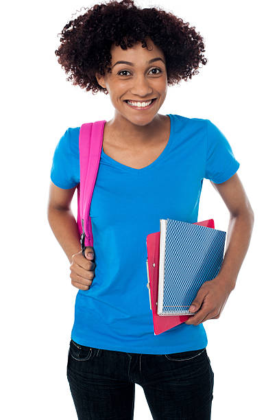 istock College student carrying back pack, book and clipboard 513475581
