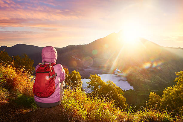 istock Woman with backpacker enjoying sunrise view at high mountains. 513475924
