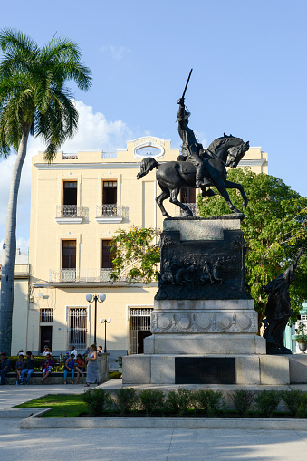 Camaguey, Cuba - 11 January 2016: People walking in front of the Ignacio Agramonte monument at Ignacio Agramonte Park in Camaguey, Cuba