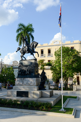 Camaguey, Cuba - 11 January 2016: People walking in front of the Ignacio Agramonte monument at Ignacio Agramonte Park in Camaguey, Cuba