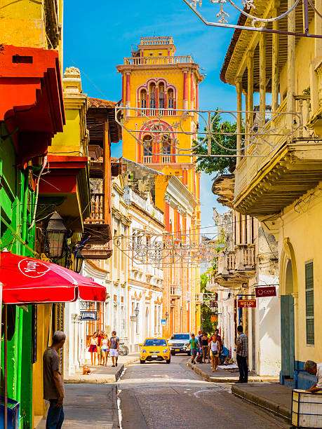 Cartagena, Colombia - December 21, 2014: Color houses in the historical district and people walking in the streets in Cartagena, Colombia