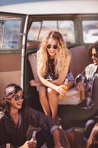 istock Hipster Multi-Ethnic Group Sitting in Back of Van Drinking Beer 513477666