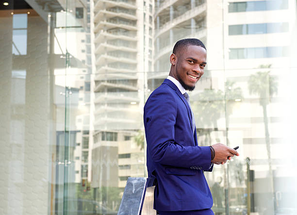 istock Smiling young businessman with cellphone 513478068