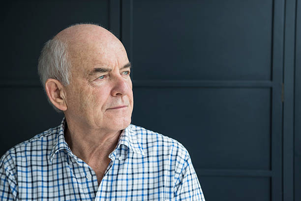 istock Senior man in his 70s looking away against grey background 513478936