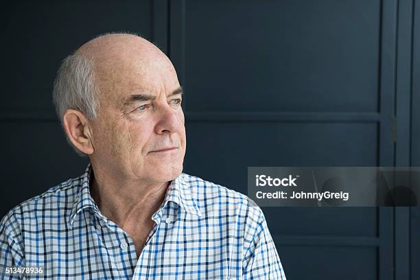 Senior Man In His 70s Looking Away Against Grey Background Stock Photo - Download Image Now