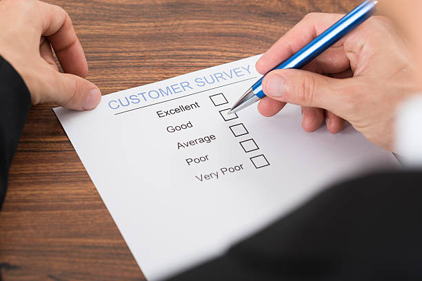 istock Person's Hand Filling Customer Survey 513480772