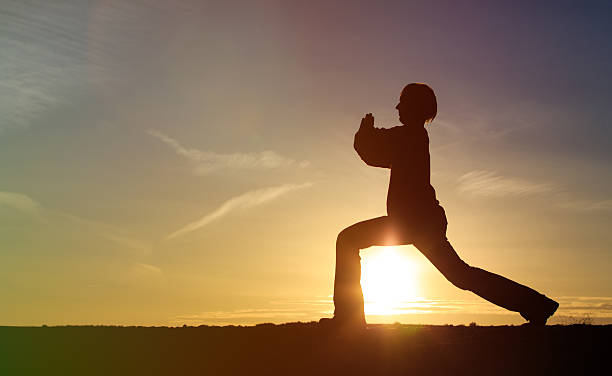 istock young man doing yoga at sunset sky 513480816