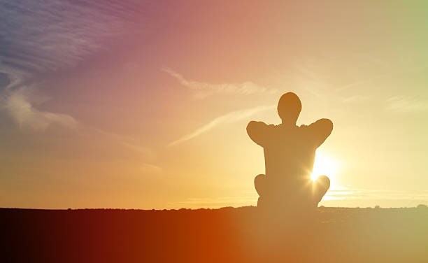 istock young man doing yoga at sunset sky 513480884