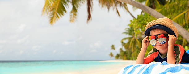 istock little boy play with sunglasses on summer beach 513481804