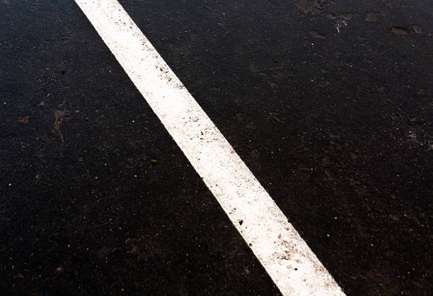 istock Traffic line on dirty ashphalt road 513481990