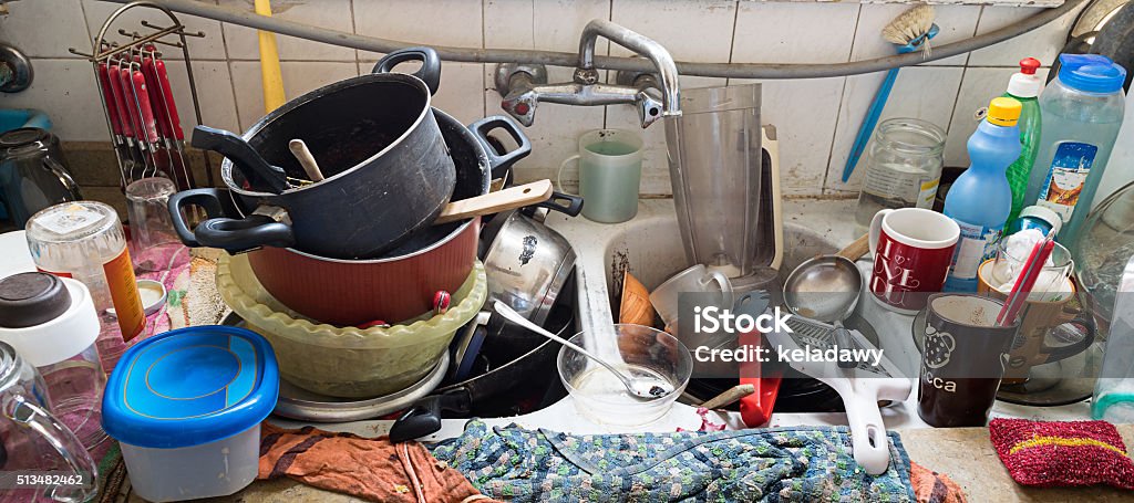 Messy Dirty Kitchen Pile of dirty utensils in a kitchen washbasin Dirty Stock Photo