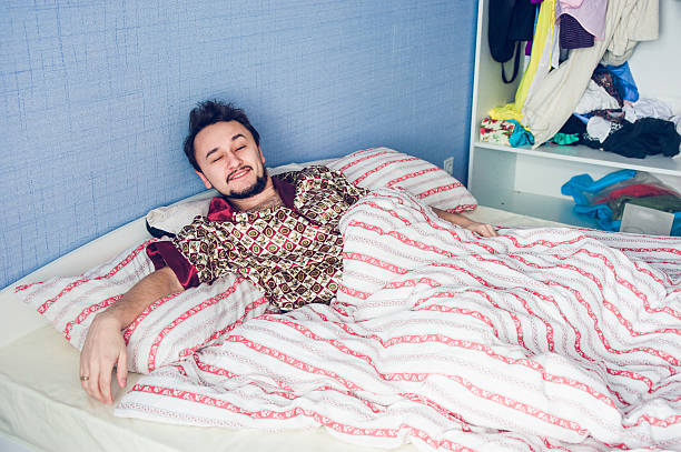 istock the young man had just woken up in bed one 513482702