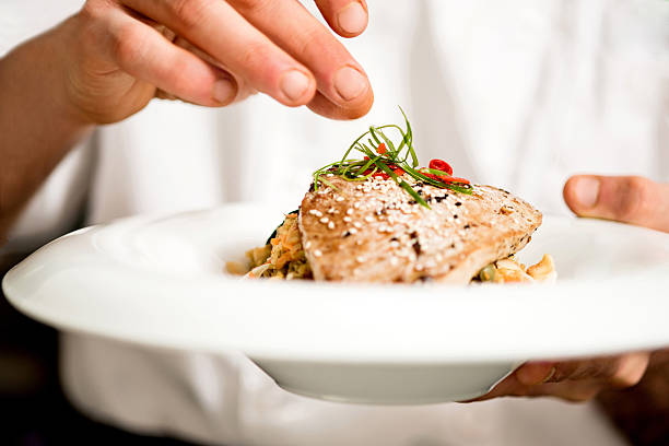 Tuna appetizer is ready to serve Chef adding final touch to tuna appetizer cooking show stock pictures, royalty-free photos & images