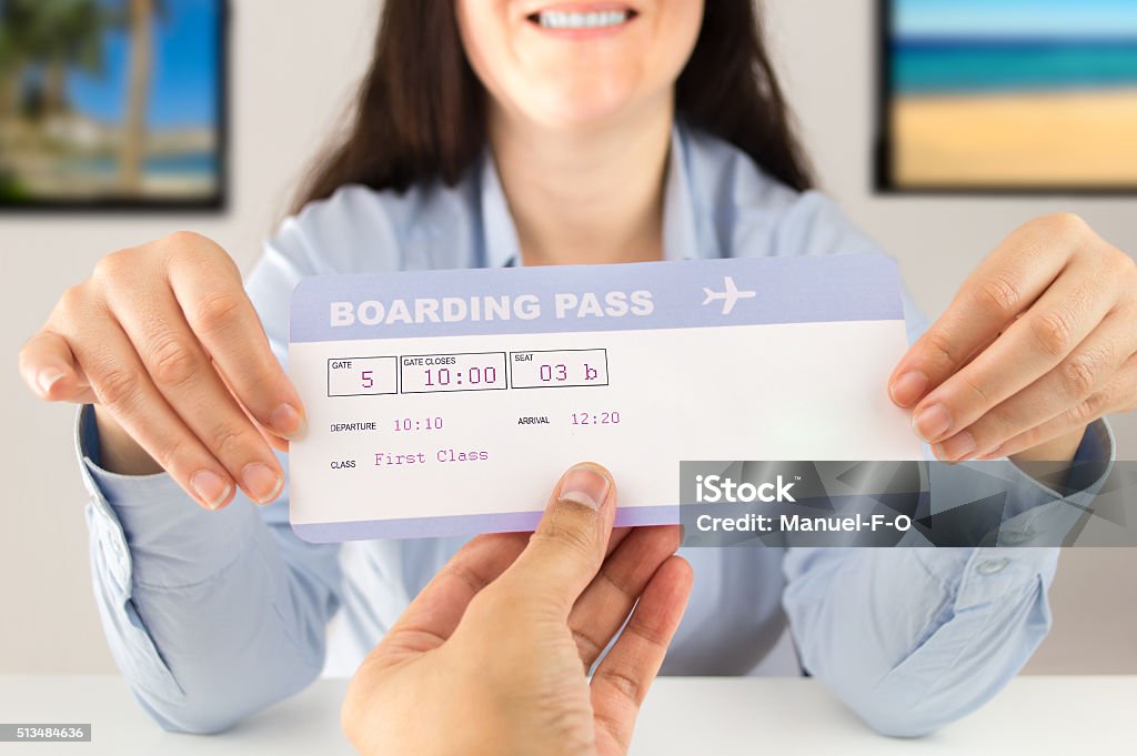 you can travel with this ticket travel agent delivering the flight ticket to the customer at the travel agency Travel Agent Stock Photo