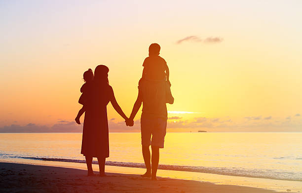 istock happy family with two kids walking at sunset 513486320