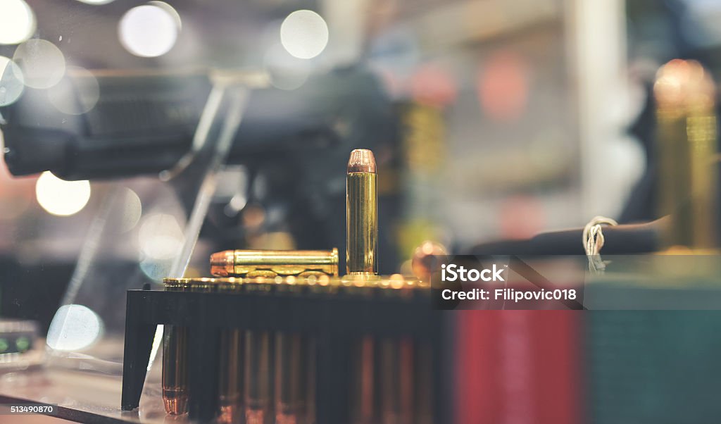 Gun Store bullets and gun on counter in retail gun store Gun Shop Stock Photo