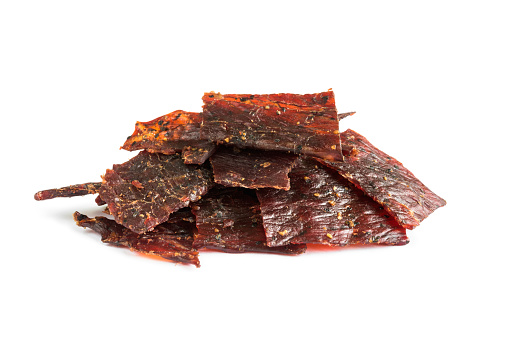 Close-up shot of beef jerky portion isolated on white background