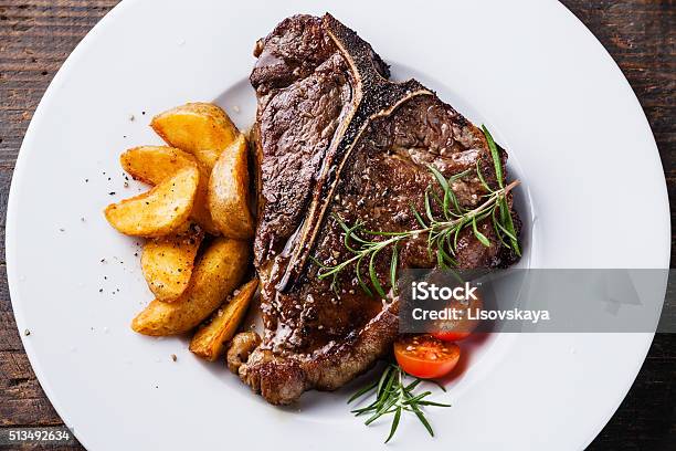 Grilled Tbone Steak With Roasted Potato Wedges Stock Photo - Download Image Now - T-bone Steak, Steak, Cooked