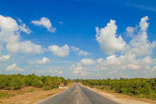 Antsirabe, Madagascar 19 october 2023. Road from Morondava to Antsirabe through empty grassland and village in central Madagascar. small thatched houses right by side of road