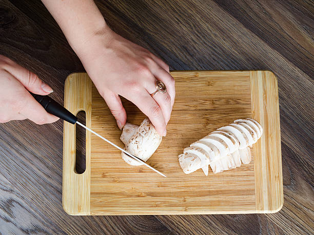 istock The girl cuts mushrooms. Top view 513493170
