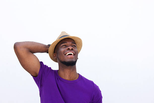 istock Young black man laughing with hand behind head 513493388