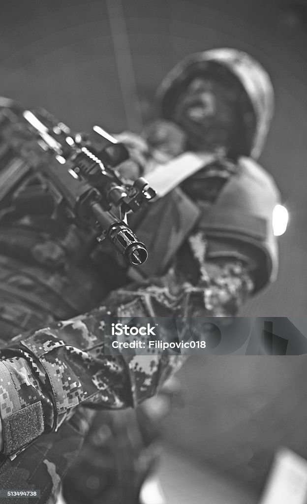 Special Forces Soldier Aiming Rifle, black and white, focus on rifle Adult Stock Photo