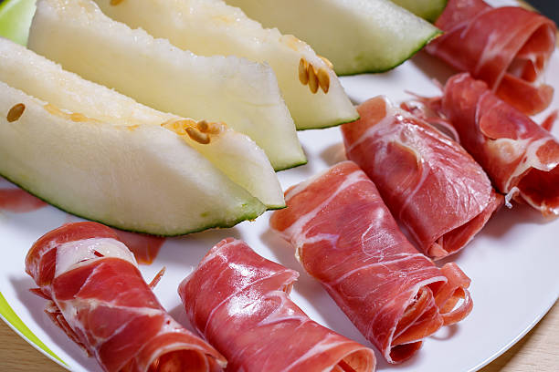 istock slices of cured pork ham jamon with melon 513495408