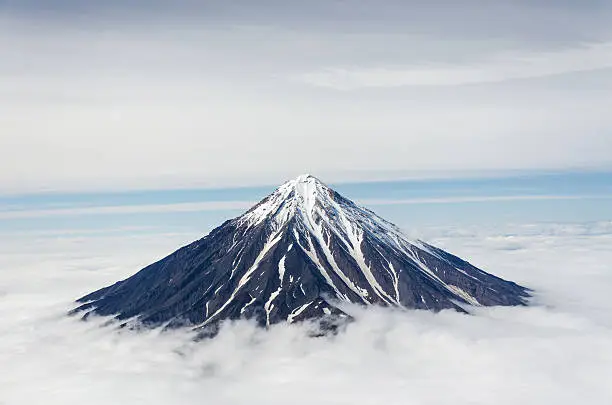 Beautiful Koryaksky volcano in Kamchatka with the snow peak above the clouds