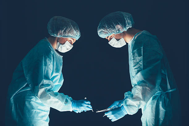 istock Medical team  hospital performing operation. Group of surgeon at work 513496516