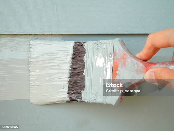 Hand Holding Brush Painting Wall Stock Photo - Download Image Now - Painting - Activity, Painting - Art Product, Outdoors