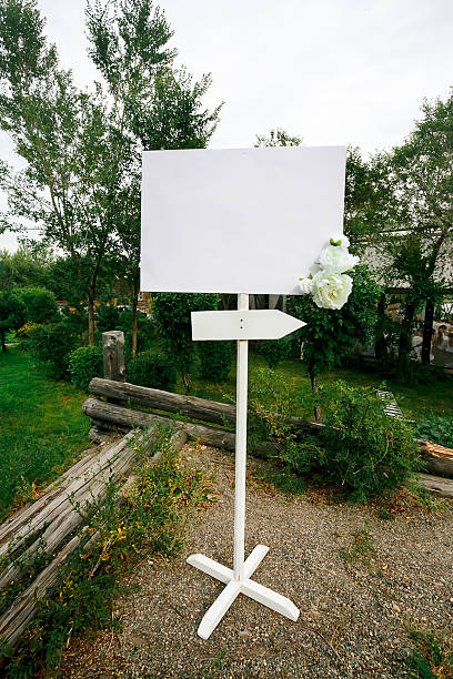 istock Blank wedding white banner with arrow sign decorated by flowers 513497266